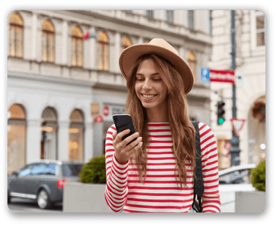 smiling-young-european-woman-enjoys-recreation-time-watches-interesting-video-website-wears-stylish-headgear-striped-sweater-01-min