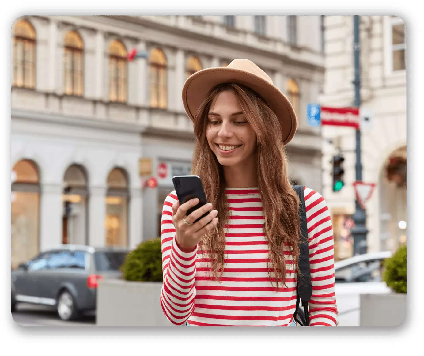 smiling-young-european-woman-enjoys-recreation-time-watches-interesting-video-website-wears-stylish-headgear-striped-sweater-01-min